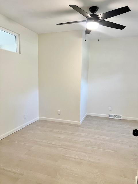 909 N Brinton Ave, Dixon, IL 61021 - empty room with light wood finished floors and a ceiling fan
