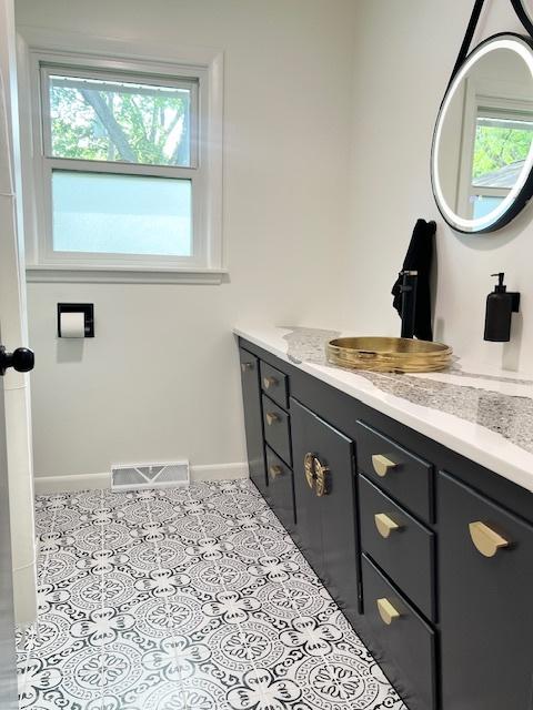 909 N Brinton Ave, Dixon, IL 61021 - bathroom featuring healthy amount of natural light, vanity, and tile patterned flooring