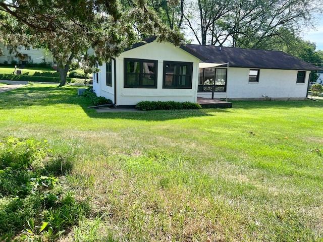 909 N Brinton Ave, Dixon, IL 61021 - back of property featuring a lawn and stucco siding