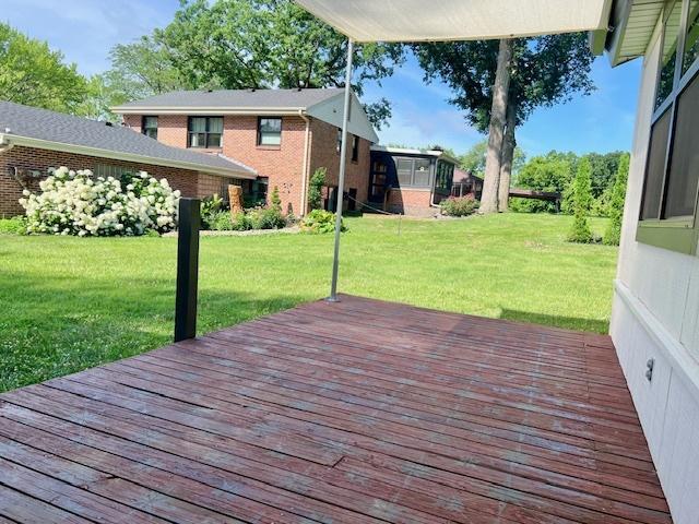 909 N Brinton Ave, Dixon, IL 61021 - wooden deck featuring a lawn