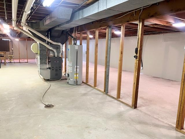 909 N Brinton Ave, Dixon, IL 61021 - unfinished basement featuring water heater and heating unit