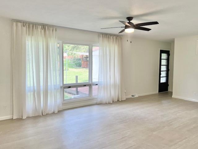 909 N Brinton Ave, Dixon, IL 61021 - empty room featuring a ceiling fan and wood finished floors