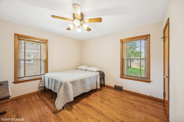 9326 S Millard Ave, Evergreen Park, IL 60805 - bedroom with multiple windows, light wood-style flooring, and ceiling fan