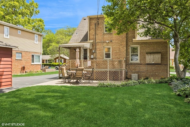 9326 S Millard Ave, Evergreen Park, IL 60805 - back of house featuring brick siding, a lawn, and a patio area