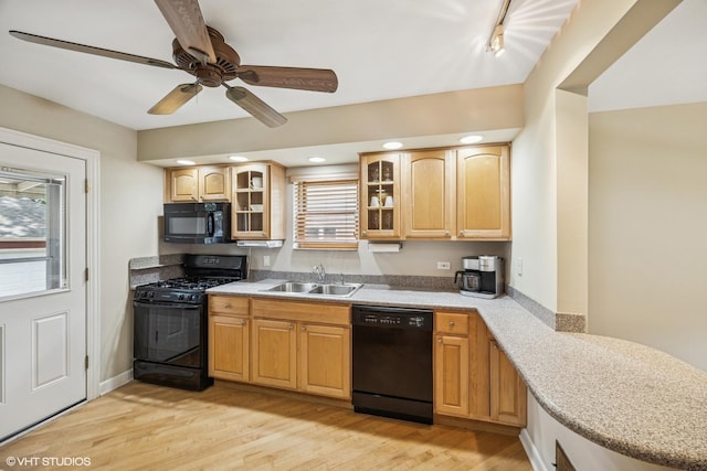 9326 S Millard Ave, Evergreen Park, IL 60805 - kitchen featuring black appliances, light wood-style floors, glass insert cabinets, light countertops, and healthy amount of natural light