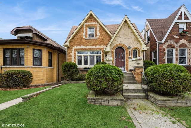 6046 N Monitor Ave, Chicago, IL 60646 - tudor house with brick siding, a front lawn, and stone siding
