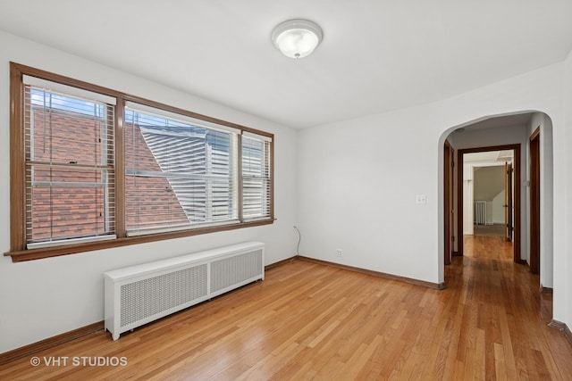 6046 N Monitor Ave, Chicago, IL 60646 - unfurnished room with radiator heating unit, arched walkways, plenty of natural light, and radiator