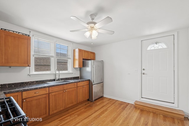 6046 N Monitor Ave, Chicago, IL 60646 - kitchen featuring freestanding refrigerator, range, brown cabinetry, and light wood finished floors