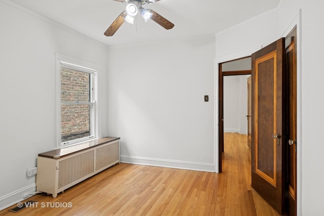 6046 N Monitor Ave, Chicago, IL 60646 - empty room with radiator heating unit, ornamental molding, light wood-style flooring, and a ceiling fan