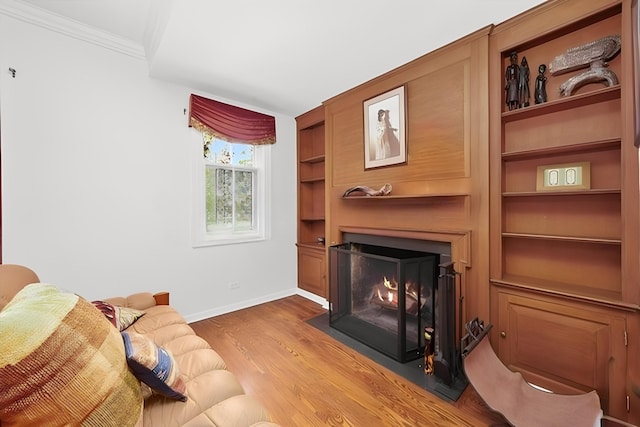 600 Riverwoods Rd, Mettawa, IL 60045 - living area featuring a fireplace with flush hearth, wood finished floors, and ornamental molding