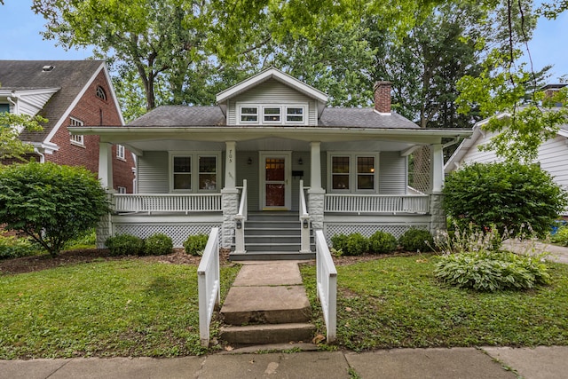 705 Arlington Ct, Champaign, IL 61820 - bungalow-style house featuring a chimney, a porch, and a front yard