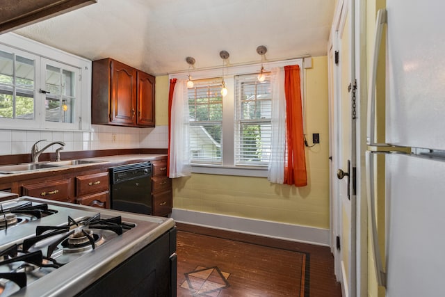 705 Arlington Ct, Champaign, IL 61820 - kitchen with freestanding refrigerator, range, dishwasher, hanging light fixtures, and dark wood-style floors