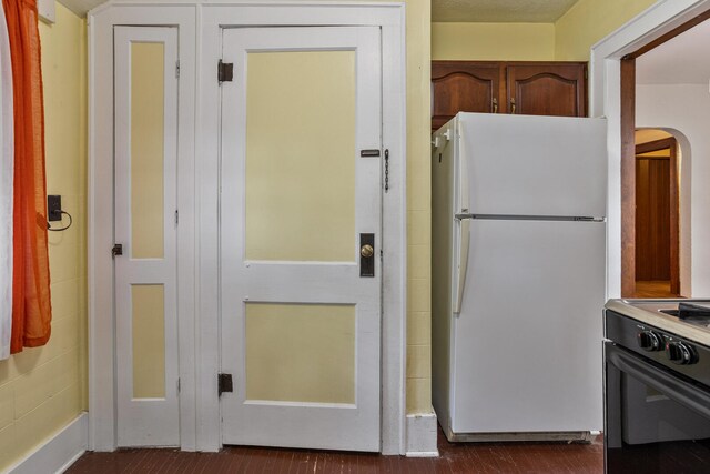 705 Arlington Ct, Champaign, IL 61820 - kitchen featuring freestanding refrigerator, black stove, and arched walkways