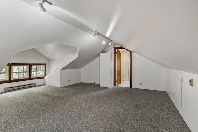 705 Arlington Ct, Champaign, IL 61820 - additional living space with a baseboard radiator, vaulted ceiling, and carpet