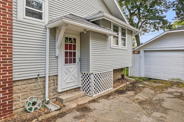 705 Arlington Ct, Champaign, IL 61820 - view of exterior entry with a garage and asphalt driveway