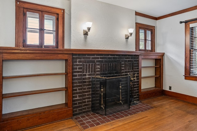 705 Arlington Ct, Champaign, IL 61820 - unfurnished living room featuring wood finished floors, a fireplace with flush hearth, and crown molding