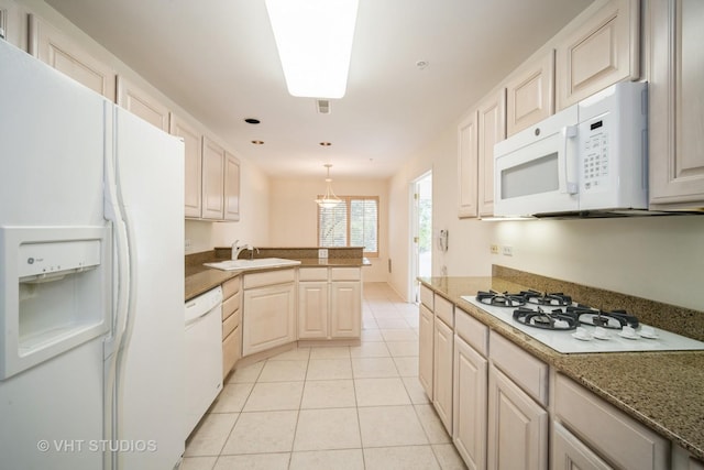 1660 1st St Unit 303, Highland Park, IL 60035 - kitchen featuring white appliances, light tile patterned flooring, a peninsula, and hanging light fixtures
