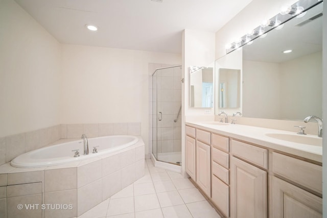 1660 1st St Unit 303, Highland Park, IL 60035 - bathroom featuring a garden tub, double vanity, a stall shower, and tile patterned flooring
