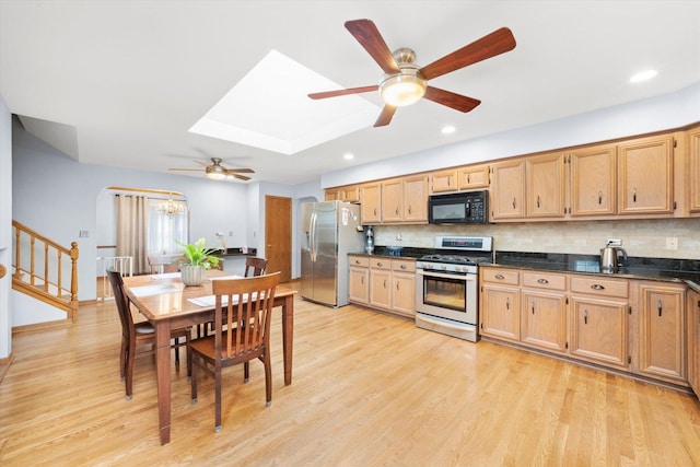 5724 W 82nd Pl, Burbank, IL 60459 - kitchen with appliances with stainless steel finishes, a ceiling fan, dark countertops, light wood-style flooring, and decorative backsplash