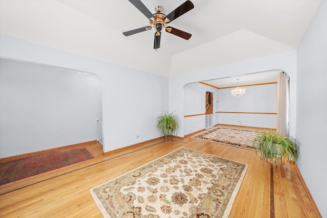 5724 W 82nd Pl, Burbank, IL 60459 - unfurnished room featuring arched walkways, ceiling fan, wood finished floors, and a chandelier
