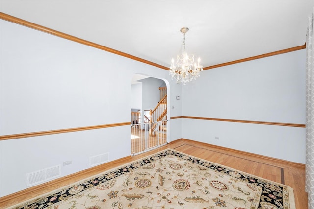 5724 W 82nd Pl, Burbank, IL 60459 - spare room with arched walkways, wood finished floors, a chandelier, and crown molding