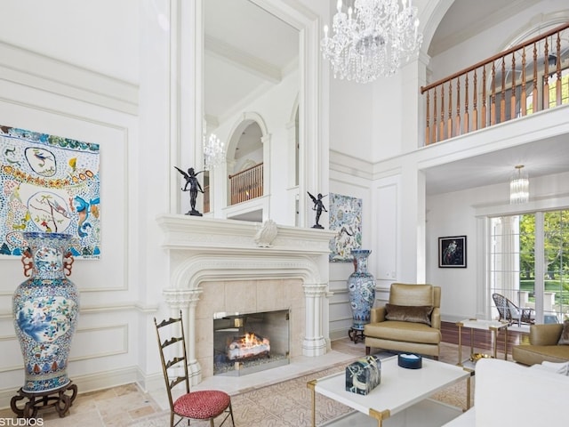 5N113 Burr Rd, Saint Charles, IL 60175 - living room with a chandelier, a decorative wall, a fireplace, stone tile flooring, and a towering ceiling