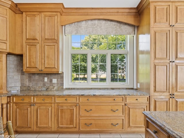 5N113 Burr Rd, Saint Charles, IL 60175 - kitchen with light stone counters, backsplash, light tile patterned flooring, and brown cabinetry