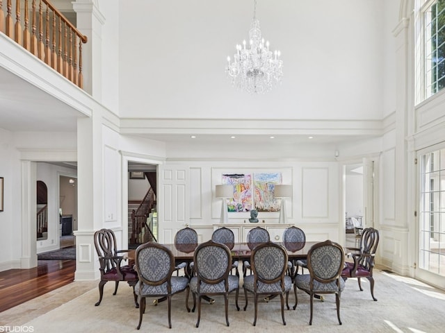 5N113 Burr Rd, Saint Charles, IL 60175 - dining space with a decorative wall, a high ceiling, stairs, plenty of natural light, and a chandelier
