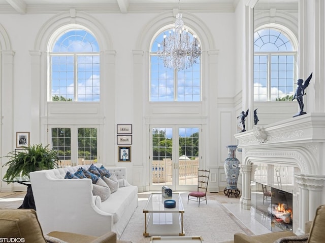 5N113 Burr Rd, Saint Charles, IL 60175 - living area with a decorative wall, a high ceiling, a chandelier, french doors, and a fireplace