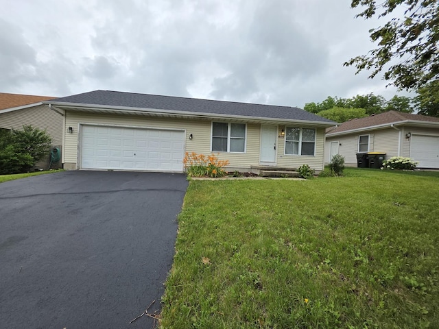 605 Tyler St, Genoa, IL 60135 - single story home featuring asphalt driveway, an attached garage, and a front lawn