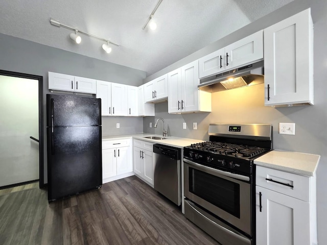 605 Tyler St, Genoa, IL 60135 - kitchen featuring appliances with stainless steel finishes, under cabinet range hood, dark wood-type flooring, and white cabinets