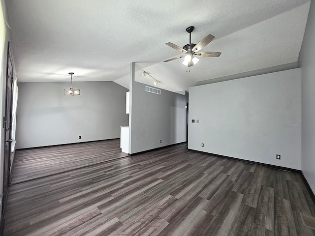 605 Tyler St, Genoa, IL 60135 - unfurnished room featuring lofted ceiling, ceiling fan, dark wood-style flooring, and a textured ceiling