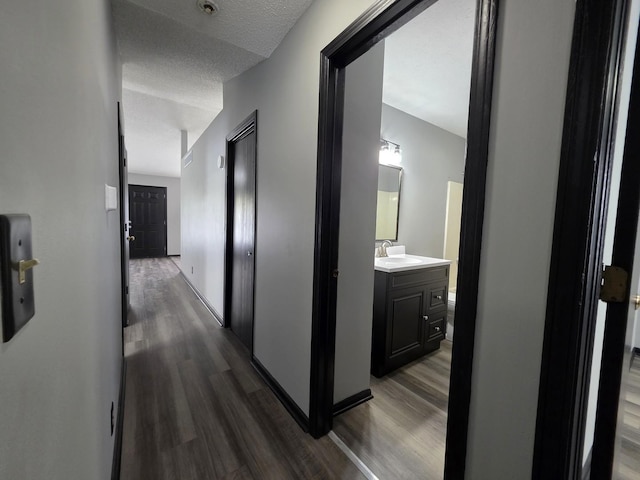 605 Tyler St, Genoa, IL 60135 - corridor featuring dark wood finished floors and a textured ceiling