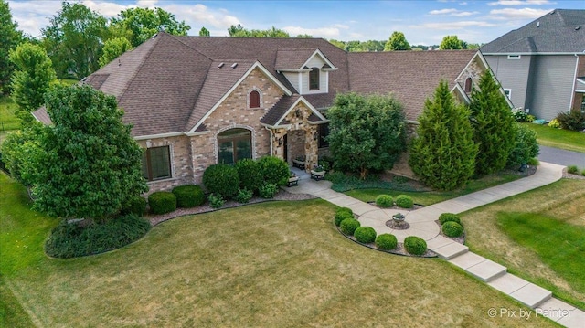 1075 Redbud Ln, Sugar Grove, IL 60554 - view of front of home featuring brick siding, a front yard, and a shingled roof