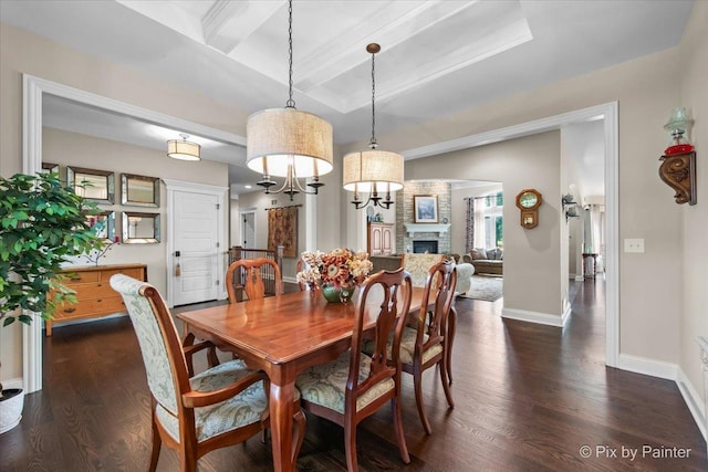 1075 Redbud Ln, Sugar Grove, IL 60554 - dining area featuring dark wood-style floors, a fireplace, beamed ceiling, coffered ceiling, and crown molding
