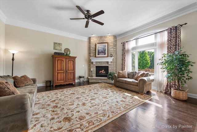 1075 Redbud Ln, Sugar Grove, IL 60554 - living room featuring ornamental molding, a ceiling fan, a stone fireplace, and dark wood-style flooring