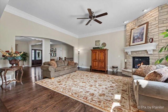 1075 Redbud Ln, Sugar Grove, IL 60554 - living room with arched walkways, a ceiling fan, dark wood finished floors, crown molding, and a fireplace