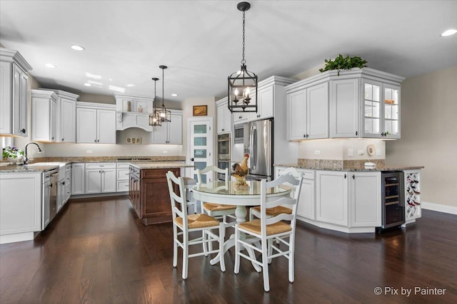1075 Redbud Ln, Sugar Grove, IL 60554 - kitchen with wine cooler, appliances with stainless steel finishes, recessed lighting, a kitchen island, and light stone counters