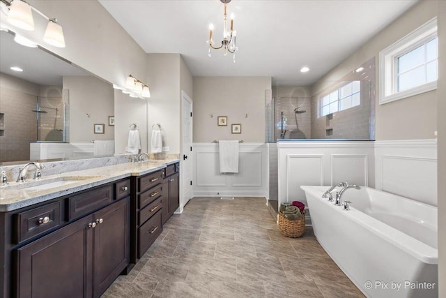 1075 Redbud Ln, Sugar Grove, IL 60554 - full bathroom featuring a walk in shower, double vanity, a decorative wall, a wainscoted wall, and a freestanding bath