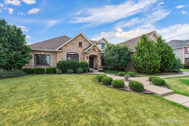 1075 Redbud Ln, Sugar Grove, IL 60554 - view of front of home featuring a front lawn, brick siding, and roof with shingles
