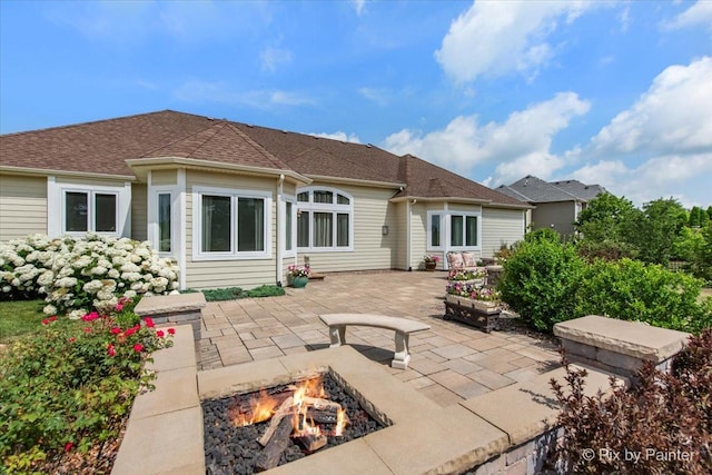 1075 Redbud Ln, Sugar Grove, IL 60554 - rear view of property with an outdoor fire pit and a patio