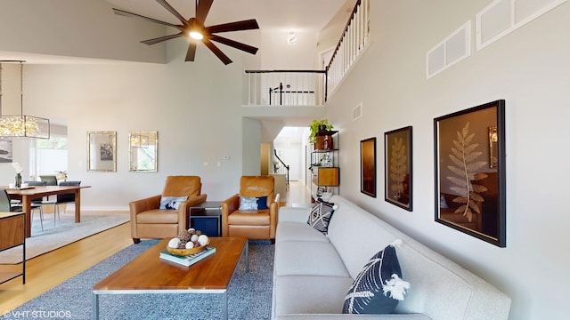 14352 Crystal Tree Dr, Orland Park, IL 60462 - living room featuring a towering ceiling, a ceiling fan, wood finished floors, plenty of natural light, and stairs