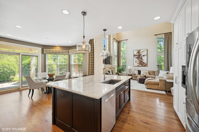 1613 Constitution Dr, Glenview, IL 60026 - kitchen featuring stainless steel appliances, white cabinets, dark brown cabinets, recessed lighting, and wood finished floors