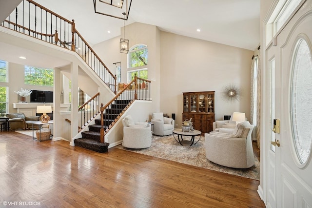 1613 Constitution Dr, Glenview, IL 60026 - foyer with healthy amount of natural light, high vaulted ceiling, stairs, wood finished floors, and recessed lighting