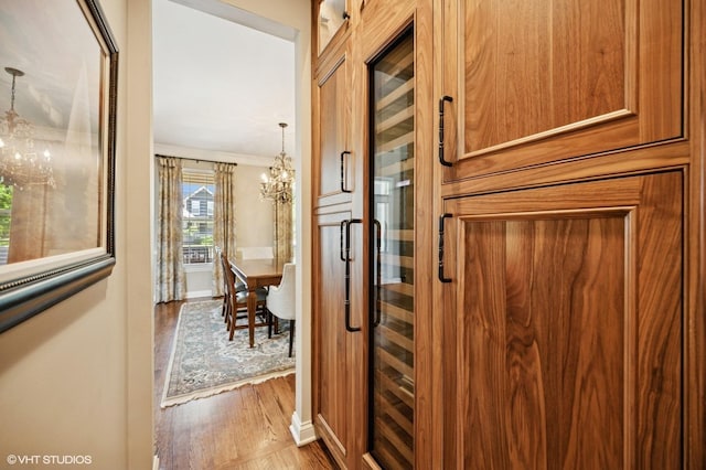 1613 Constitution Dr, Glenview, IL 60026 - hall featuring a chandelier, wood finished floors, and ornamental molding