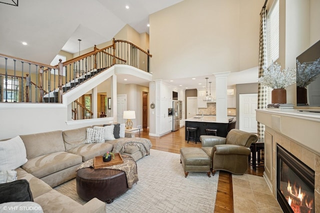 1613 Constitution Dr, Glenview, IL 60026 - living room with a towering ceiling, a fireplace, stairs, light wood finished floors, and recessed lighting