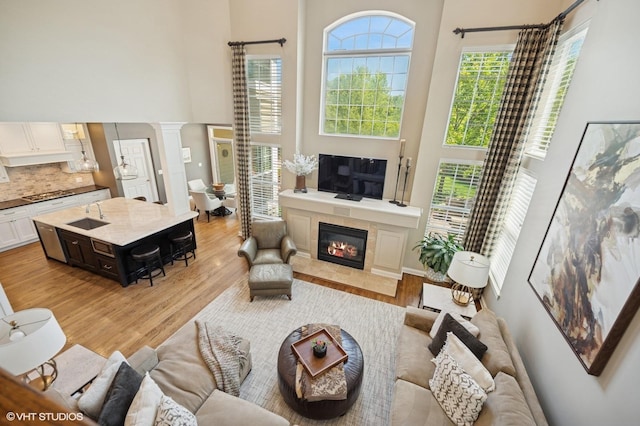 1613 Constitution Dr, Glenview, IL 60026 - living area featuring a towering ceiling, light wood-type flooring, and a tile fireplace