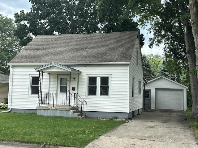 1506 17th Ave, Sterling, IL 61081 - cape cod-style house featuring an outbuilding, a detached garage, a shingled roof, concrete driveway, and a front lawn