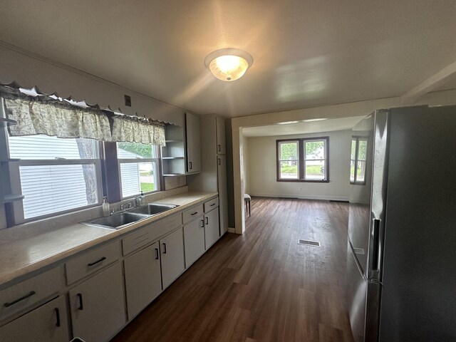 1506 17th Ave, Sterling, IL 61081 - kitchen with freestanding refrigerator, dark wood-type flooring, light countertops, white cabinets, and open shelves