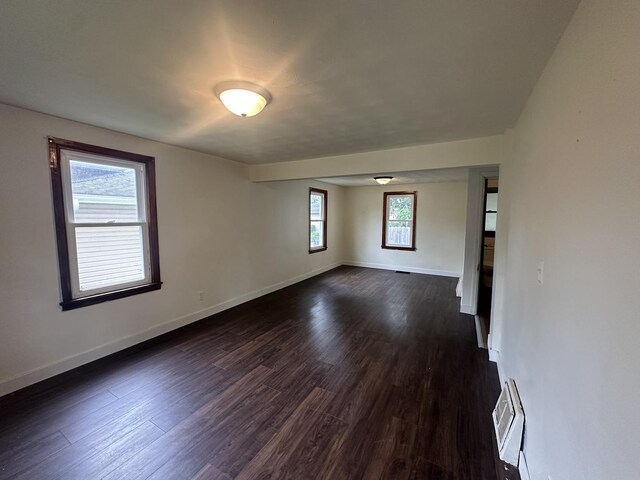 1506 17th Ave, Sterling, IL 61081 - spare room with baseboards and dark wood-style flooring